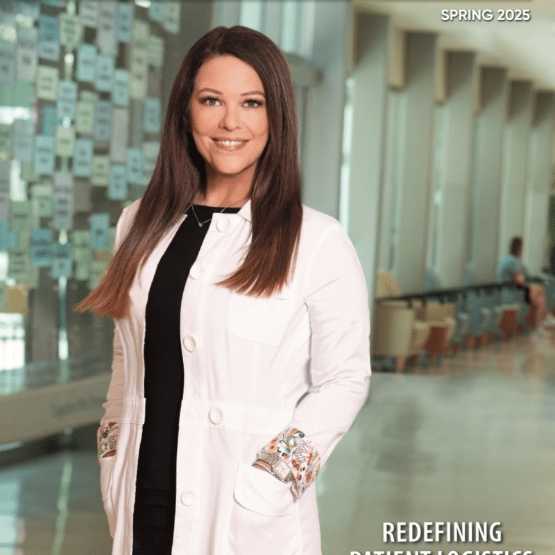 A woman in a white lab coat stands in a modern hallway with glass walls and seating. The text "Spring 2025" and "Redefining Patient Logistics with Healthcare Workforce Optimization Technology" appears on the image.